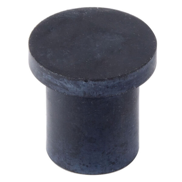 A close-up of a black cylinder with a black round knob on top.