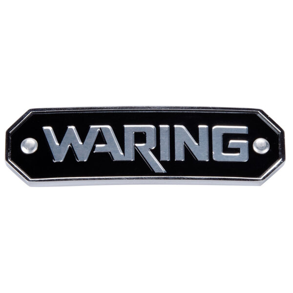 A white Waring name plate with black and silver text.