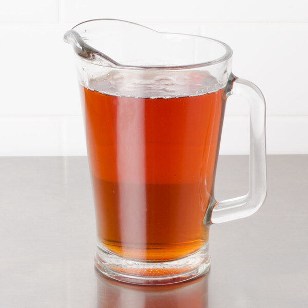 A glass pitcher of Bromley Black Tea with Raspberry Iced Tea on a countertop.
