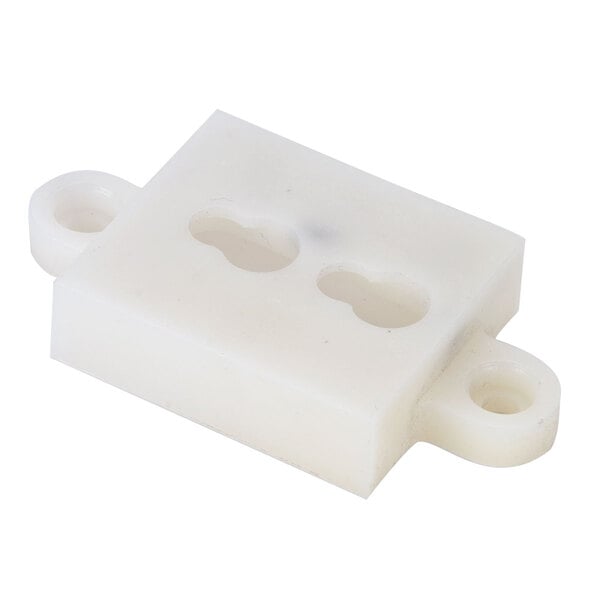 A close up of a white plastic block with two holes.
