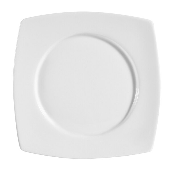 A bright white CAC porcelain plate with a circular design on a square plate.