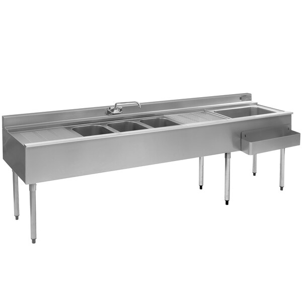 An Eagle Group stainless steel underbar sink with three sinks, two drainboards, and a faucet.