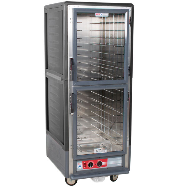 A large grey Metro C5 hot holding cabinet with clear Dutch doors.