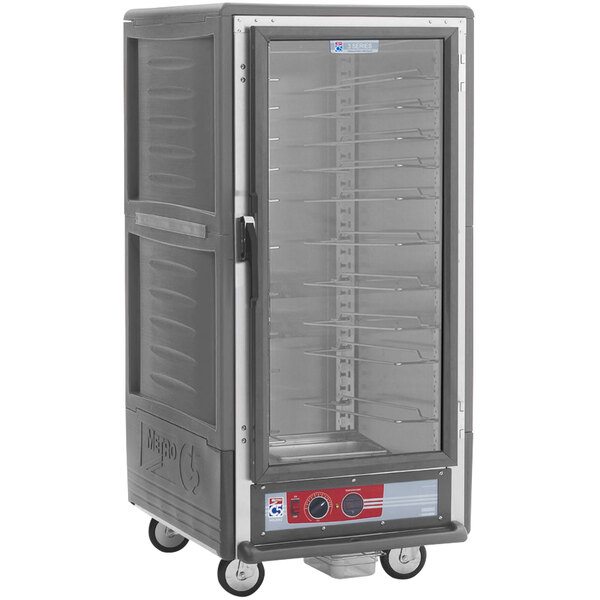A large grey Metro heated holding cabinet with a clear door on a cart.