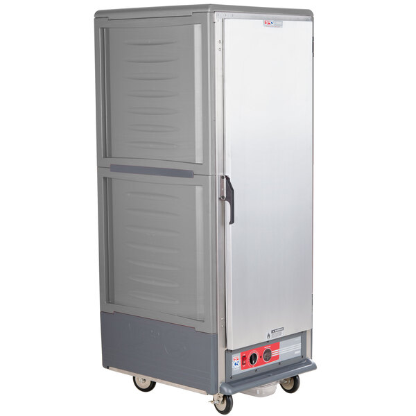 A large grey Metro C5 hot holding cabinet with a solid door on wheels.