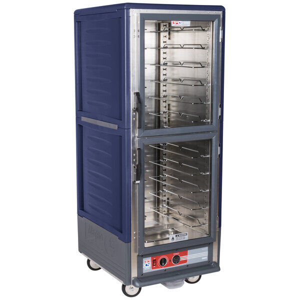 A blue and silver Metro C5 hot holding cabinet on wheels with clear Dutch doors.