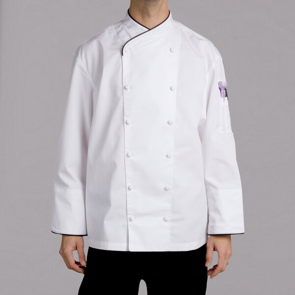 A man wearing a white Chef Revival long sleeve chef coat with black piping.