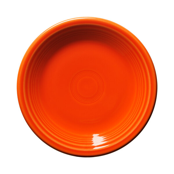 A white china salad plate with an orange border and circle in the center.