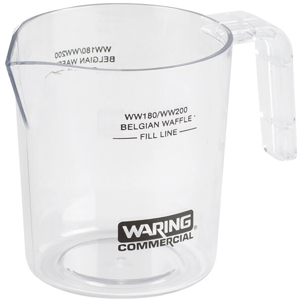 A clear plastic measuring cup with the Waring label.
