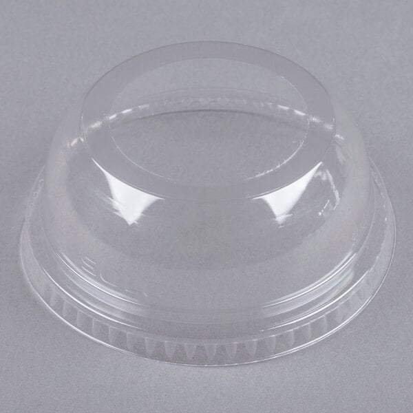 A clear plastic dome lid with a round hole.