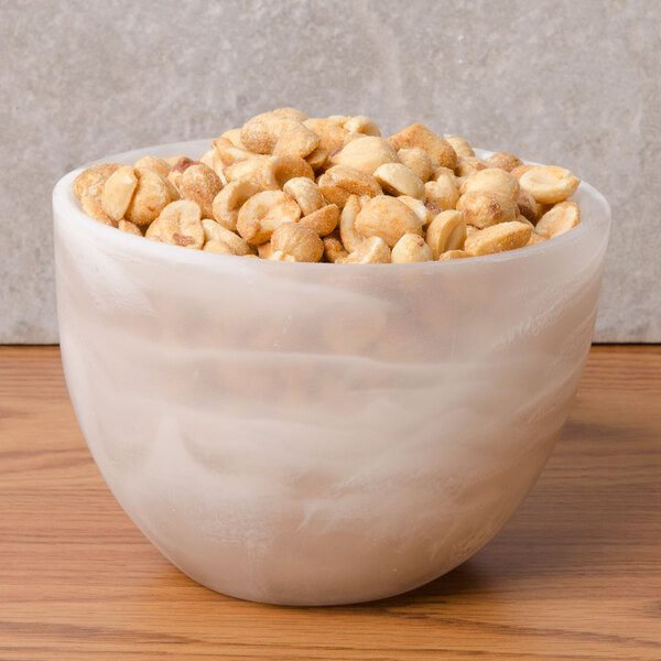 An American Metalcraft Translucence bowl filled with peanuts on a table.
