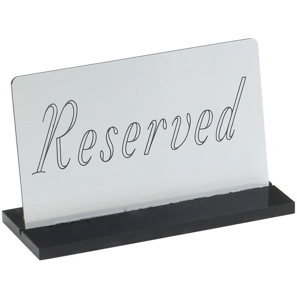A silver Cal-Mil reserved sign holder on a table.