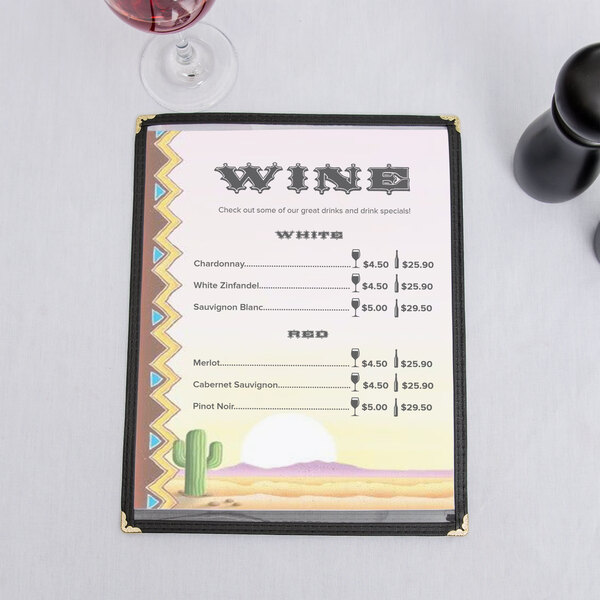 Menu paper with a Southwest cactus design on a table with a glass of wine.