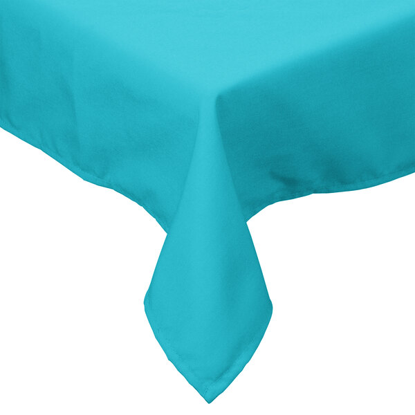 A teal rectangular Intedge tablecloth with hemmed edges on a table.