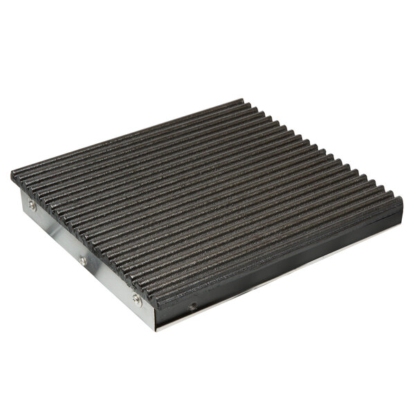 A black metal square plate with metal grooves.