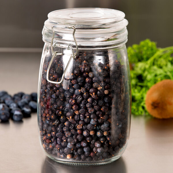 An American Metalcraft glass hinged apothecary jar filled with blueberries.