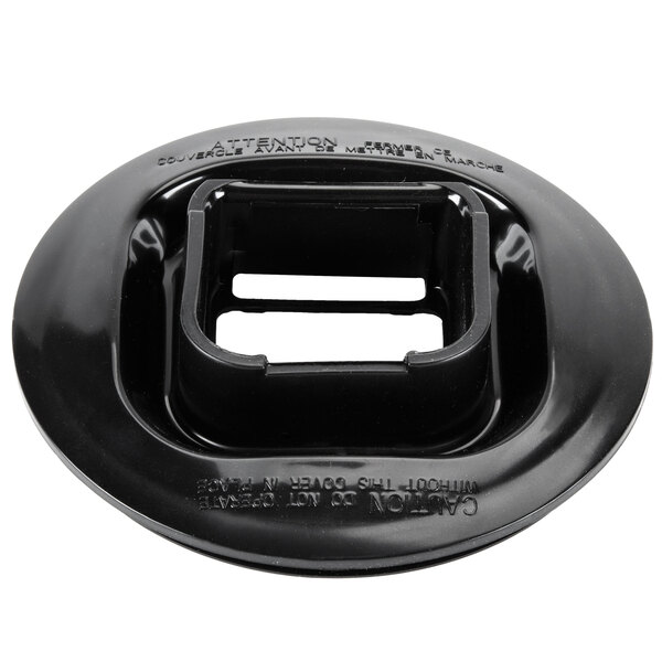 A black plastic Waring outer jar lid with a square hole.