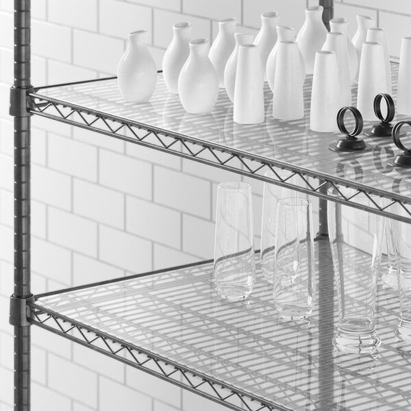 A Regency shelf with white vases and glasses on a white surface with a close-up of a white PVC shelf liner.