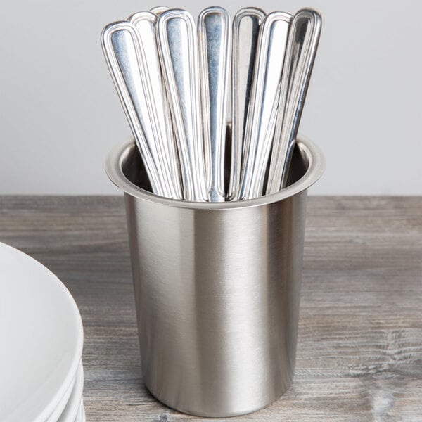 A stainless steel cup with silverware in it.
