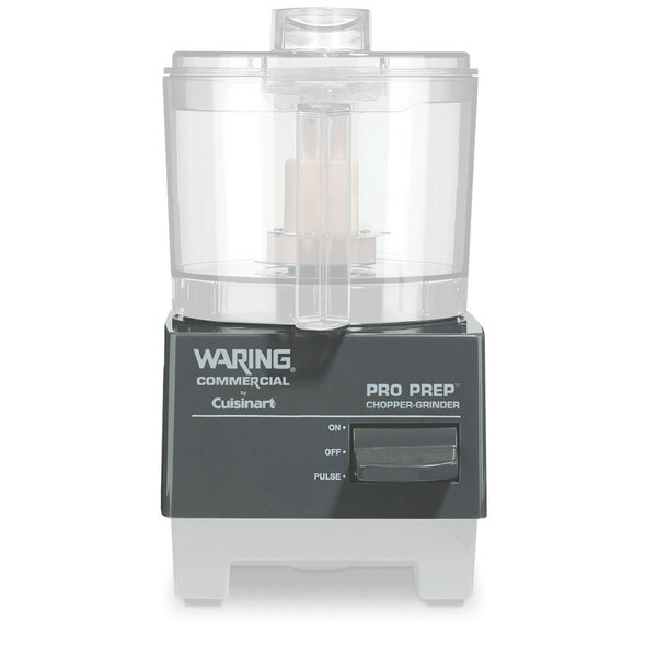 A white Waring food processor housing with a chopper grinder inside.