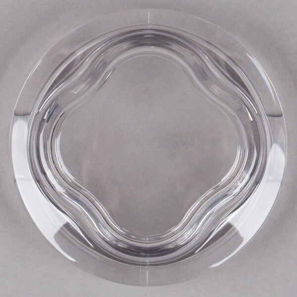 A clear plastic lid with a circular design.