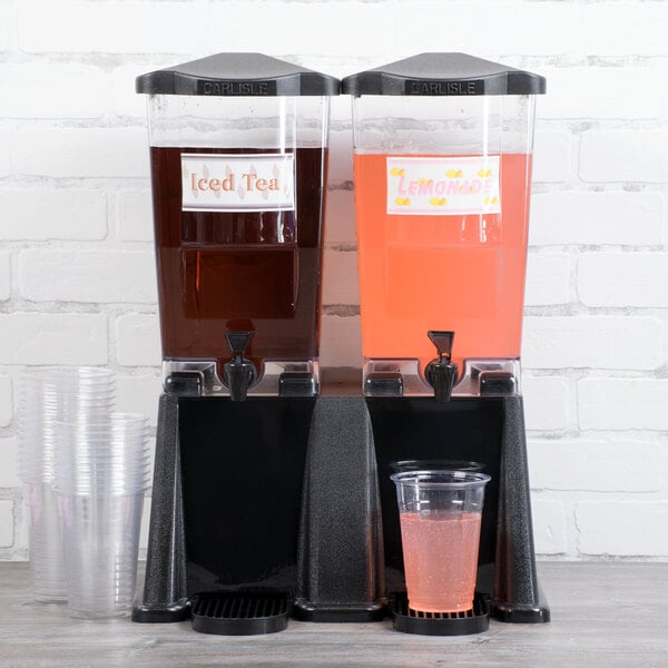 A Carlisle TrimLine Double plastic beverage dispenser with two cups of pink and brown drinks.