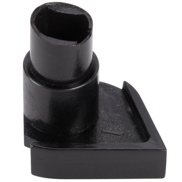 A close-up of a black plastic Waring spindle support with a hole in it.