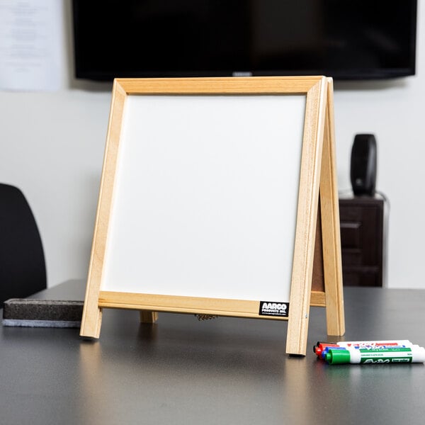 A white tabletop A-frame with a white marker board on top.