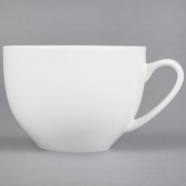 A white CAC Majesty European Bone China cup with a handle.