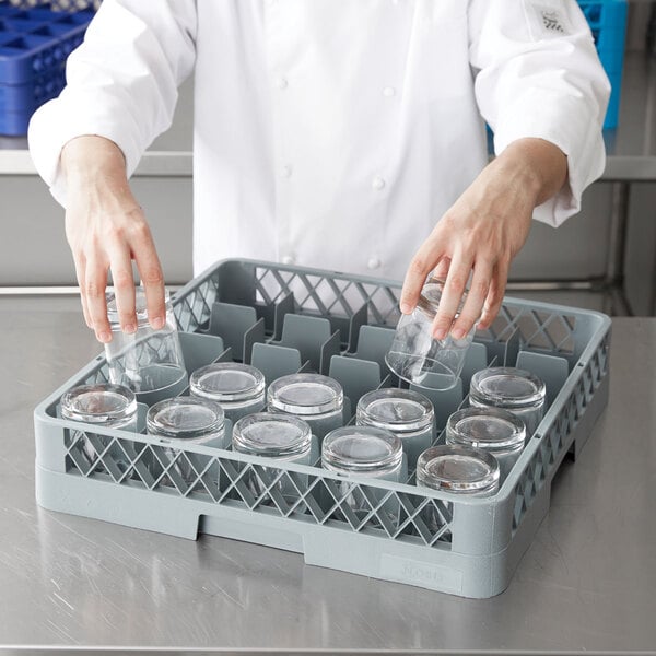 A person in a white coat putting glasses in a Noble Products glass rack.