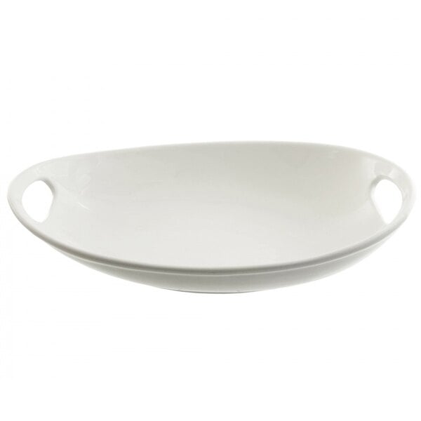 A white porcelain oval platter with handles.