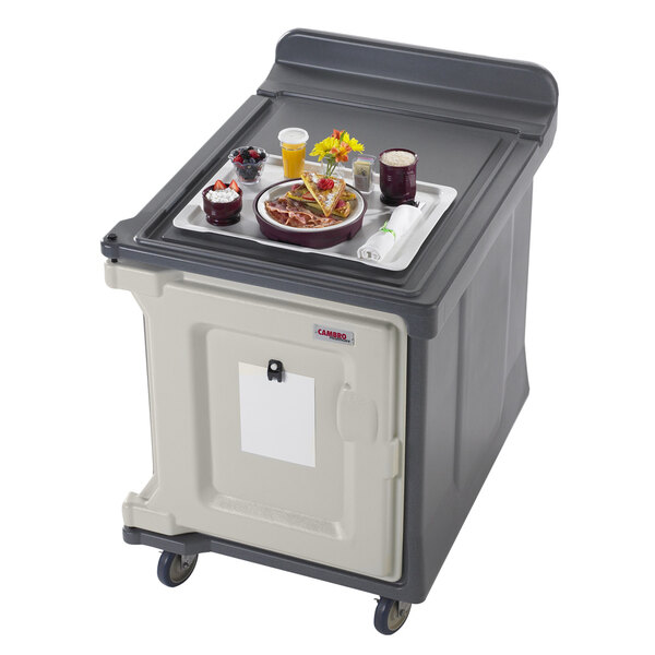 A Cambro meal delivery cart with trays of food on it.