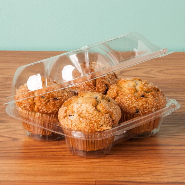 A close up of three muffins in a clear plastic InnoPak container.