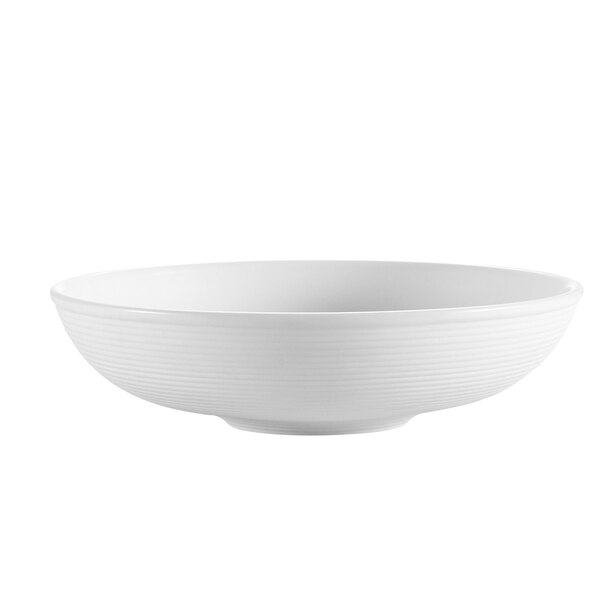 A CAC bright white porcelain salad bowl with a thin rim.