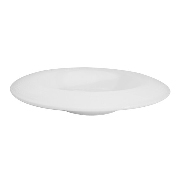 A CAC porcelain pasta bowl with a bright white draping rim on a white surface.