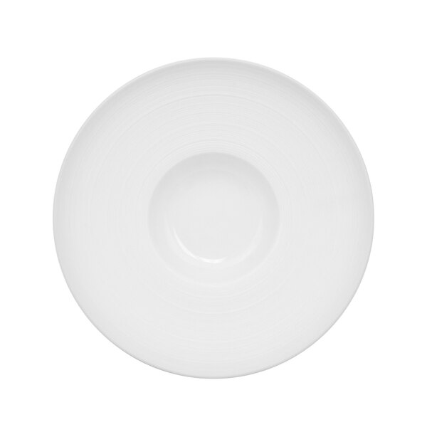 A bright white porcelain bowl with a circular pattern on the rim.