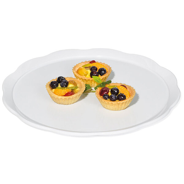 A white GET round display platter with fruit tarts on it.