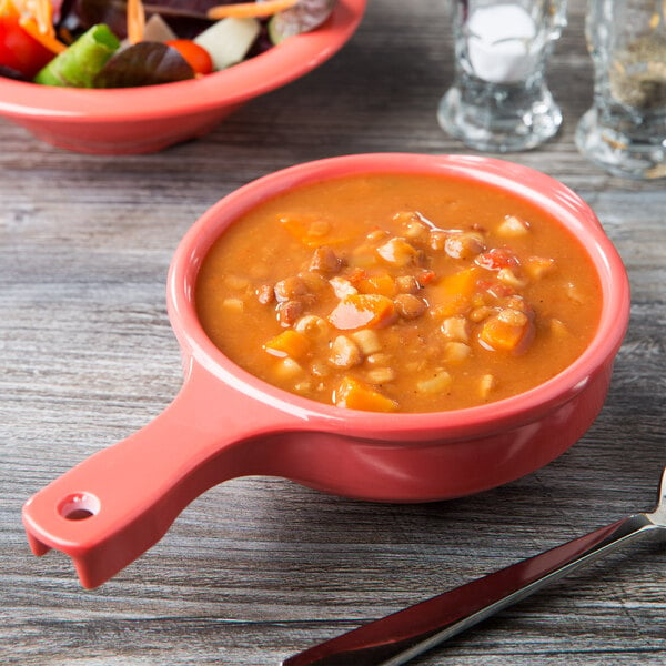A GET Creative Table bowl with handle filled with soup on a table.