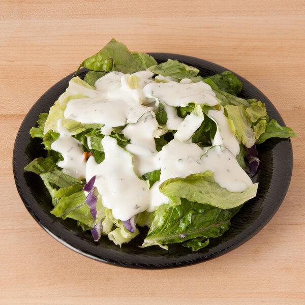 A GET black melamine plate with salad on it.