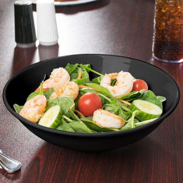 A black Elegance melamine bowl filled with salad, shrimp, and vegetables.