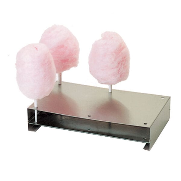 A Paragon 7900 cotton candy machine metal holder with cotton candy on sticks.