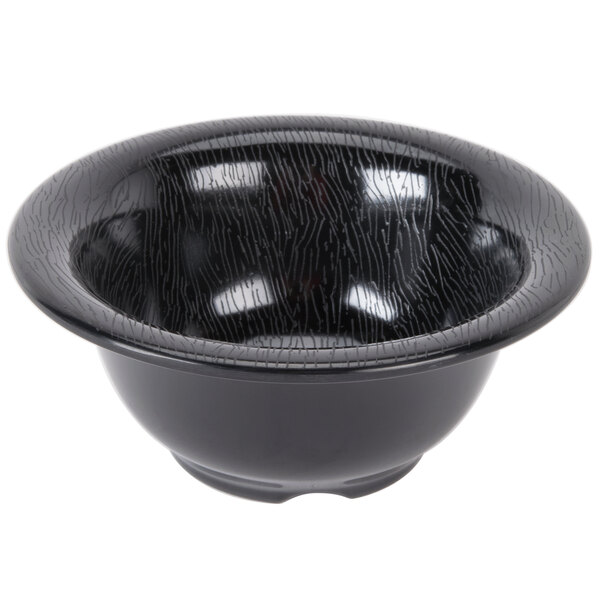 A close-up of a black bowl with a white textured pattern.