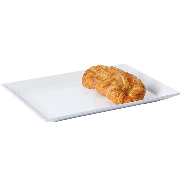 A white rectangular melamine display tray with croissants on it.