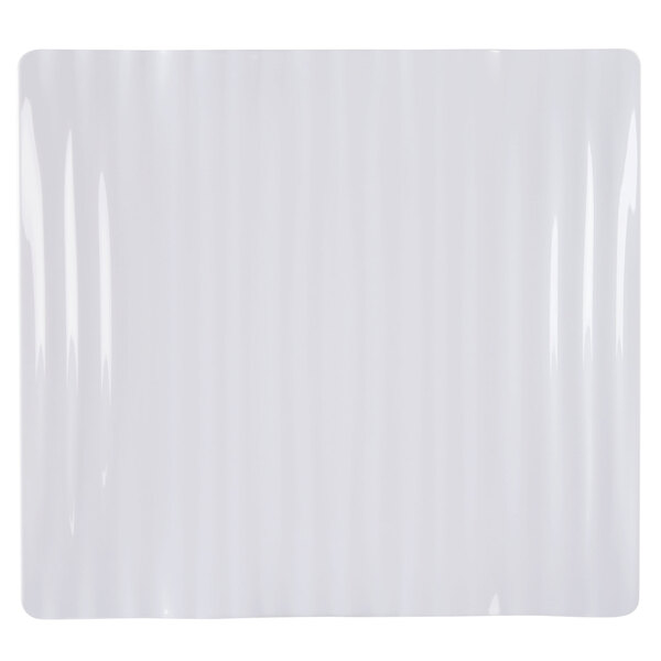 A white rectangular melamine plate with a wavy edge.