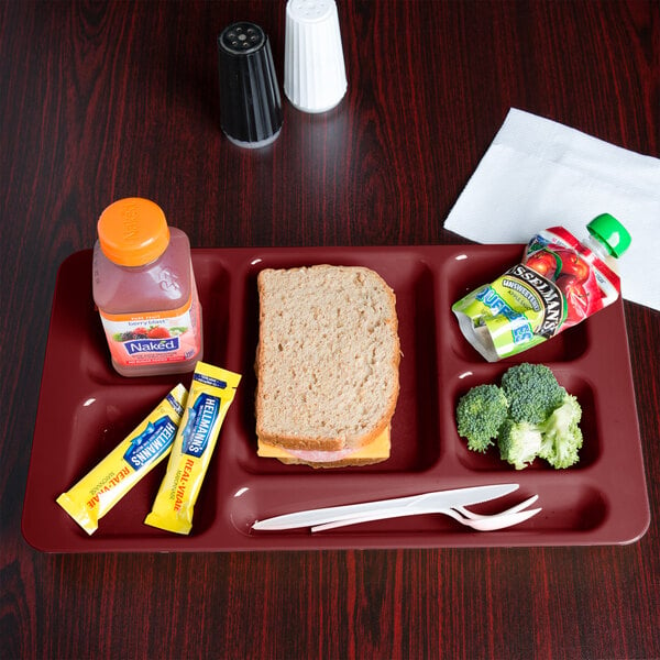 A Cambro cranberry compartment tray with a sandwich, drink, and snack on it.