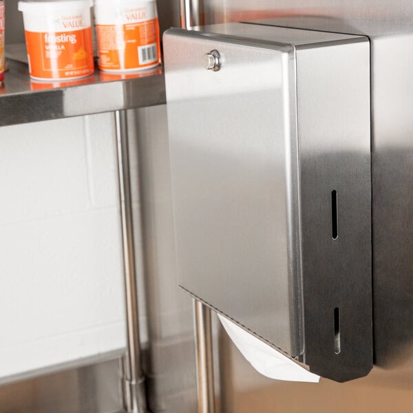A stainless steel surface mounted paper towel dispenser.