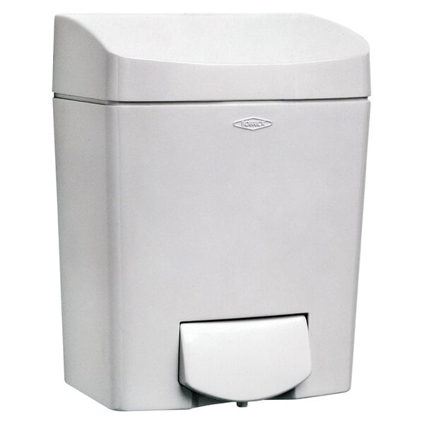 A white plastic container with a Bobrick MatrixSeries surface mounted soap dispenser.