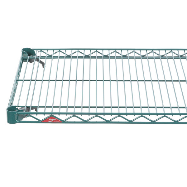 A green Metroseal wire shelf with a metal frame.