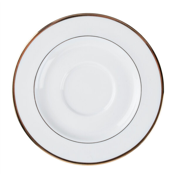 A bright white porcelain saucer with a white rim and gold accents.