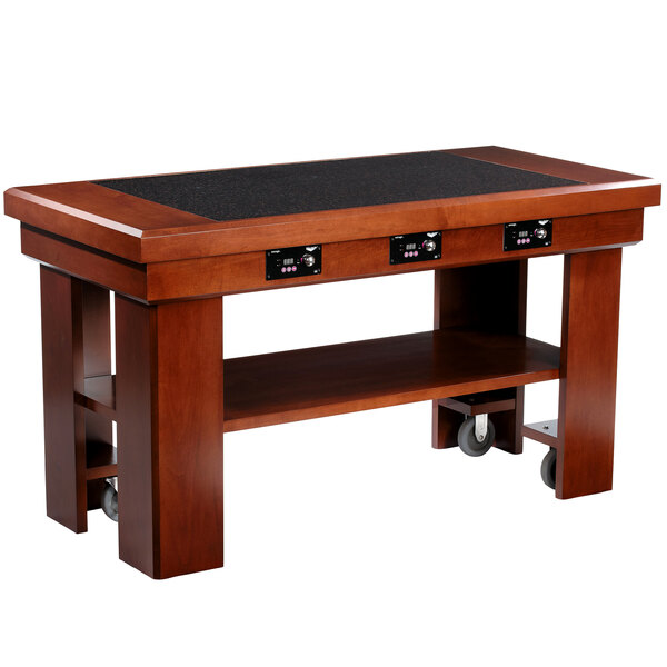 A dark cherry wooden Vollrath induction buffet table with wheels.